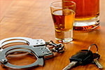 Drinks keys and handcuffs over a table